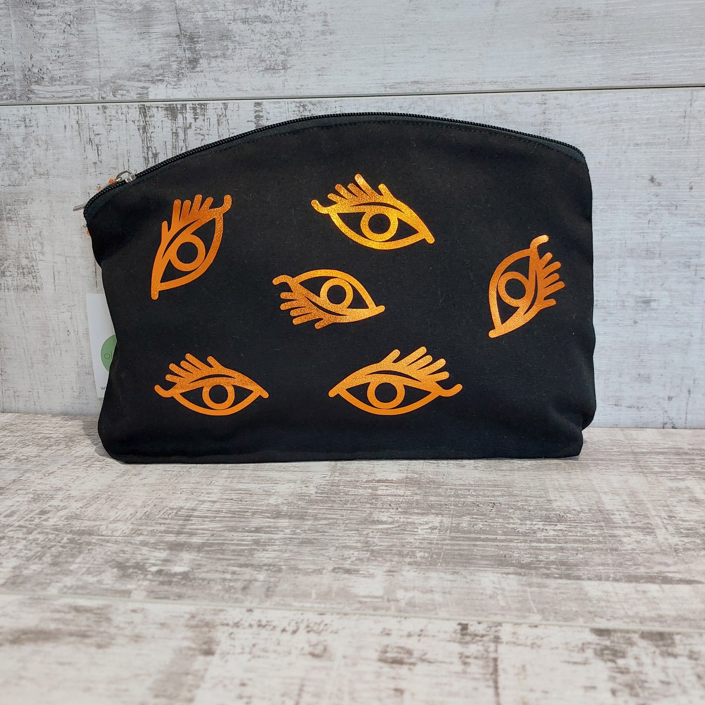 Black zip pouch with copper eyes print by Olganna.