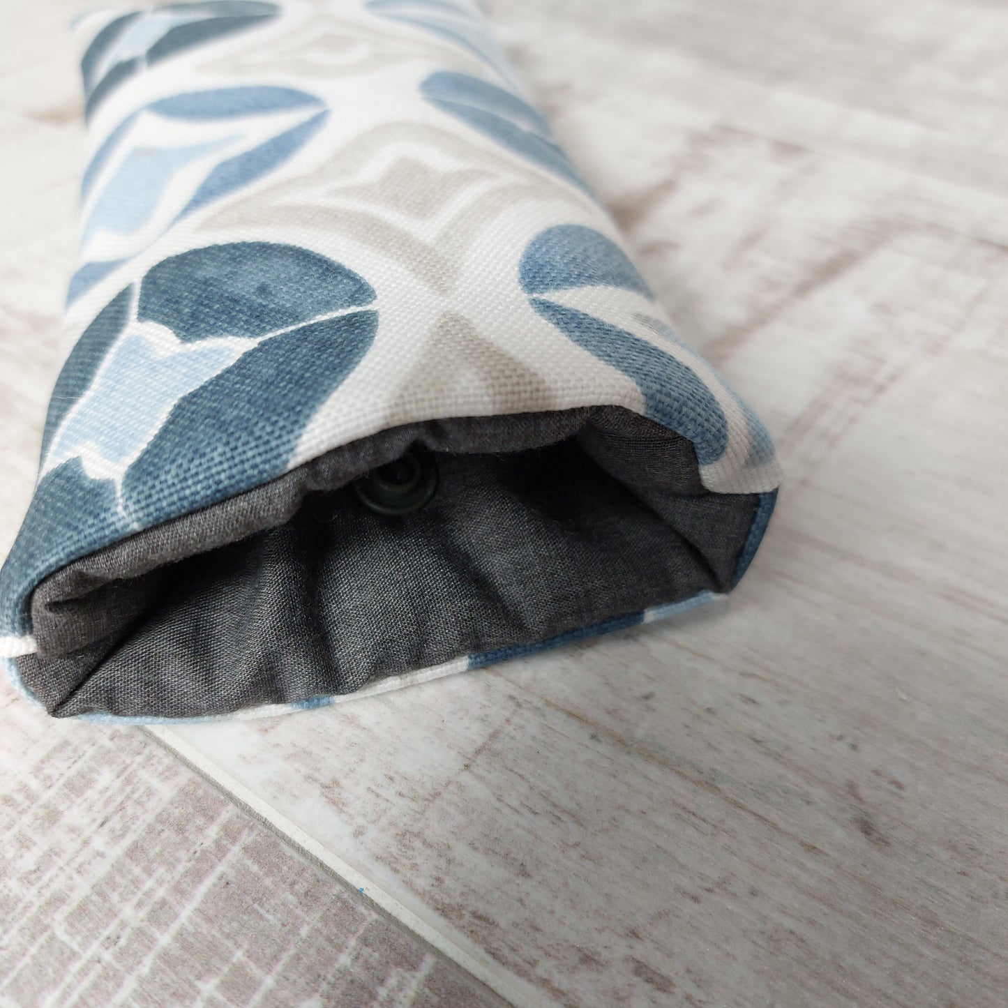 Close-up of blue Moroccan tile sunglasses case showing padded lining and snap fastening.