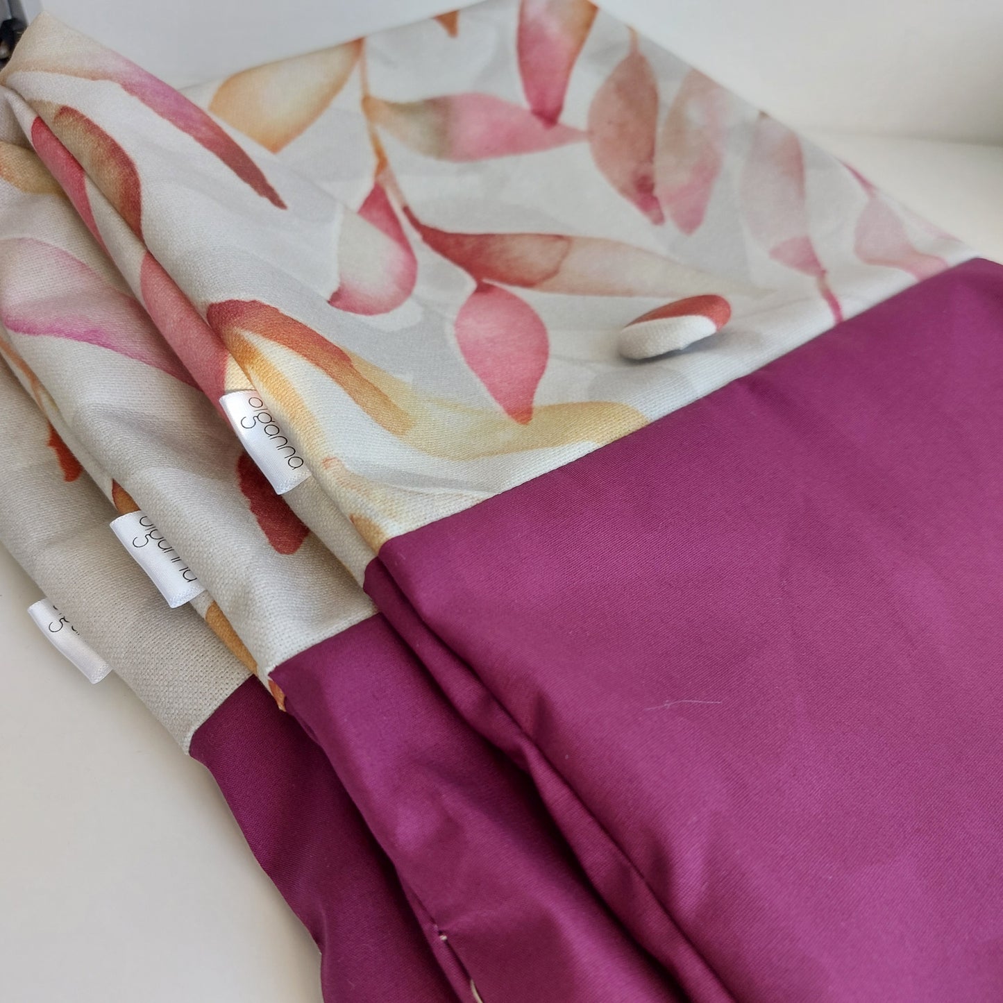 Three overlapping autumn leaf print bags with Olganna label.