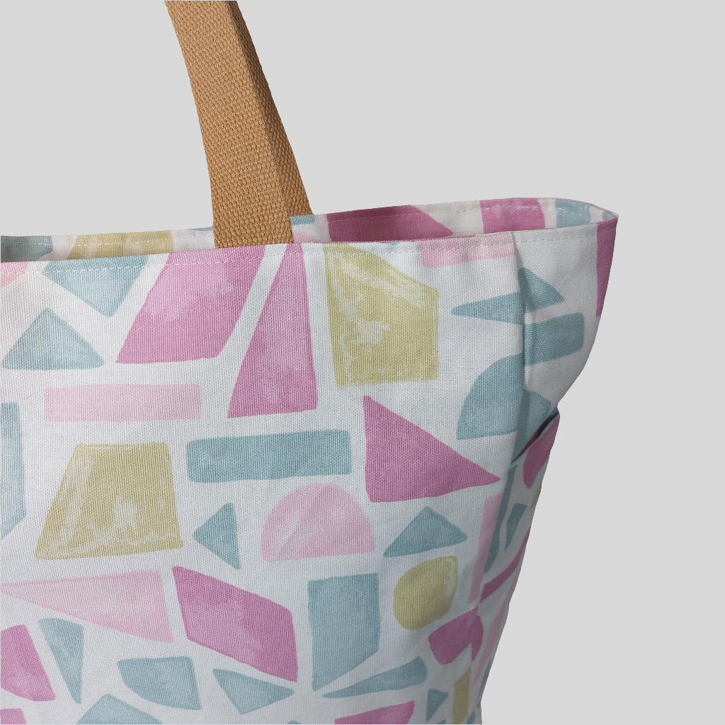 Close-up view of pink pastels summery beach bag showing outer pocket.