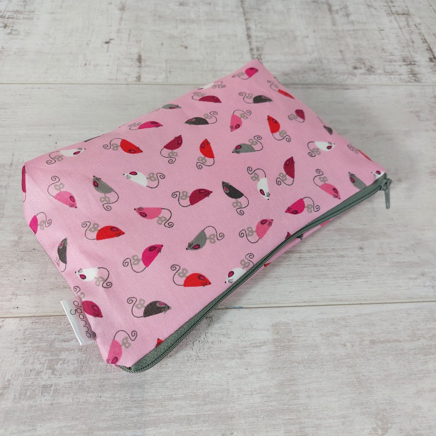 Pink mice print makeup bag, lying down.