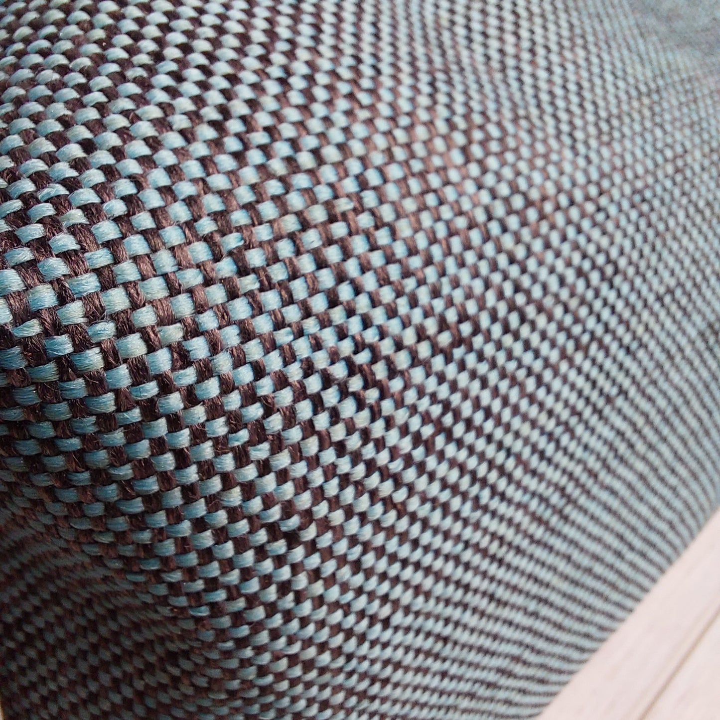 Teal and black woven fabric on the boxy zip pouch by Olganna.