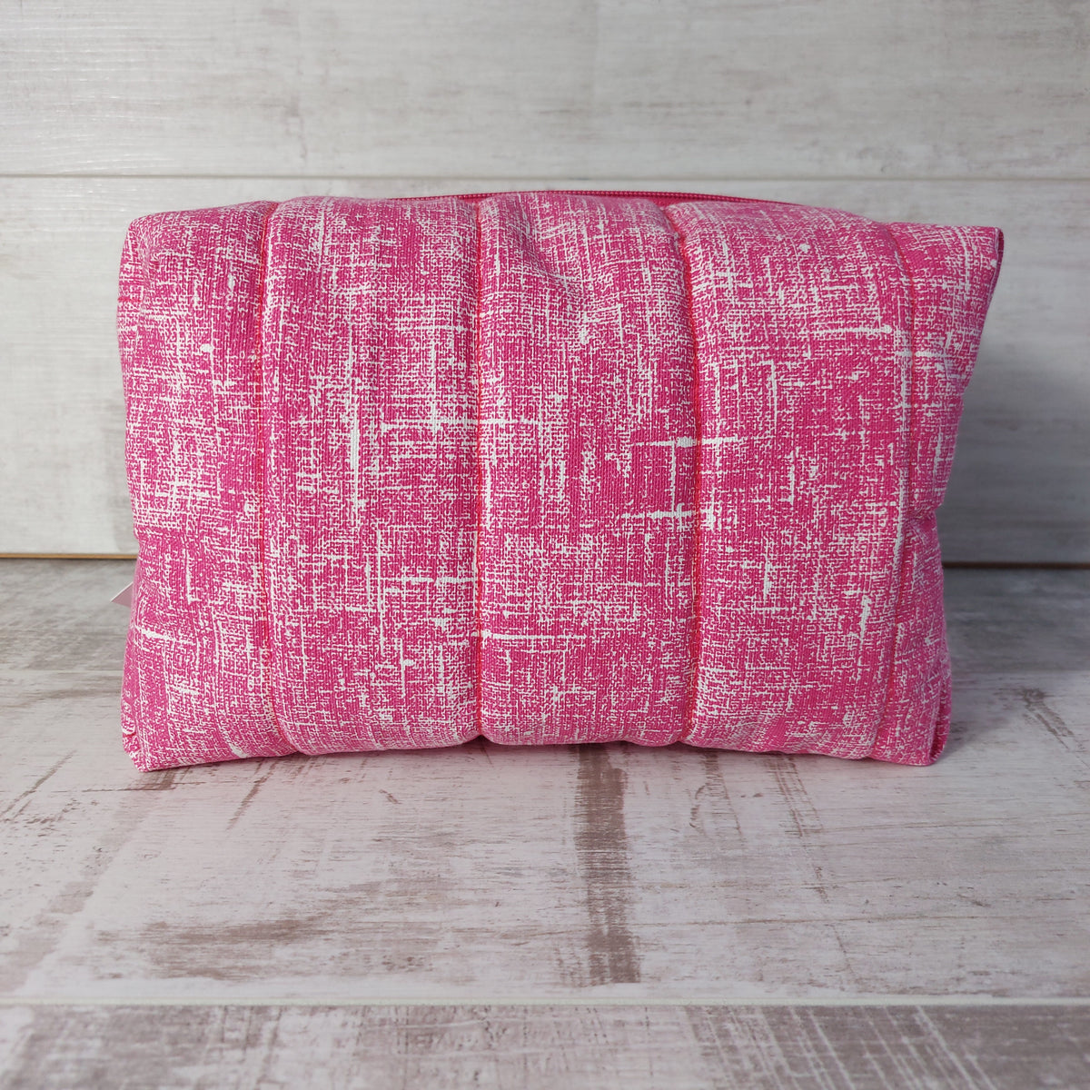 Pink quilted large toiletries bag, side view.