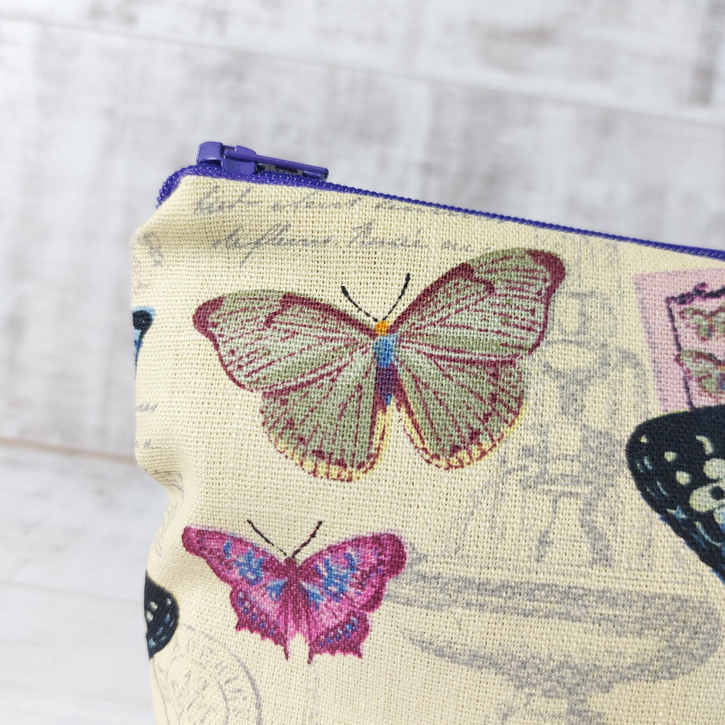 Close-up view, vintage butterfly print makeup bag.