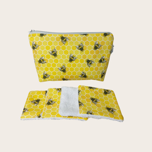 Makeup bag, front view, with four bamboo face wipes, in yellow honeycomb bee print.