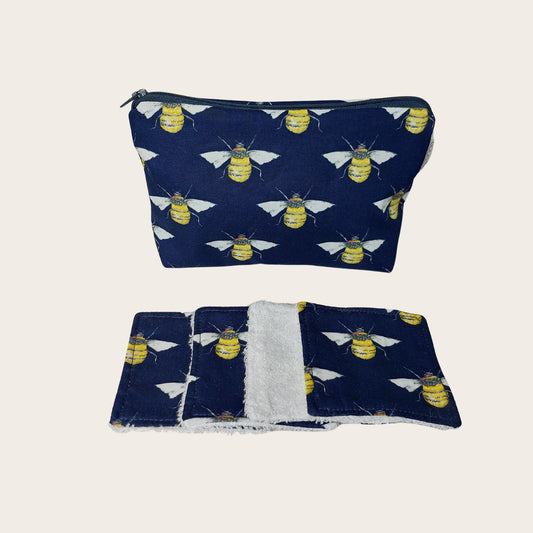 Makeup bag, front view, with four bamboo face wipes, in navy bee print.