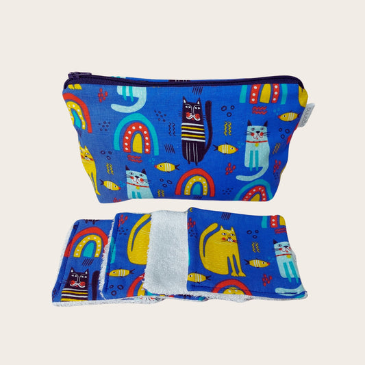 Makeup bag, front view, with four bamboo face wipes, in blue rainbow, cat and fish print. 