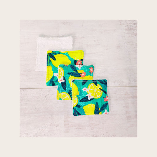 Four bamboo face wipes overlapping, in bold green and yellow Sicilian lemon print. 
