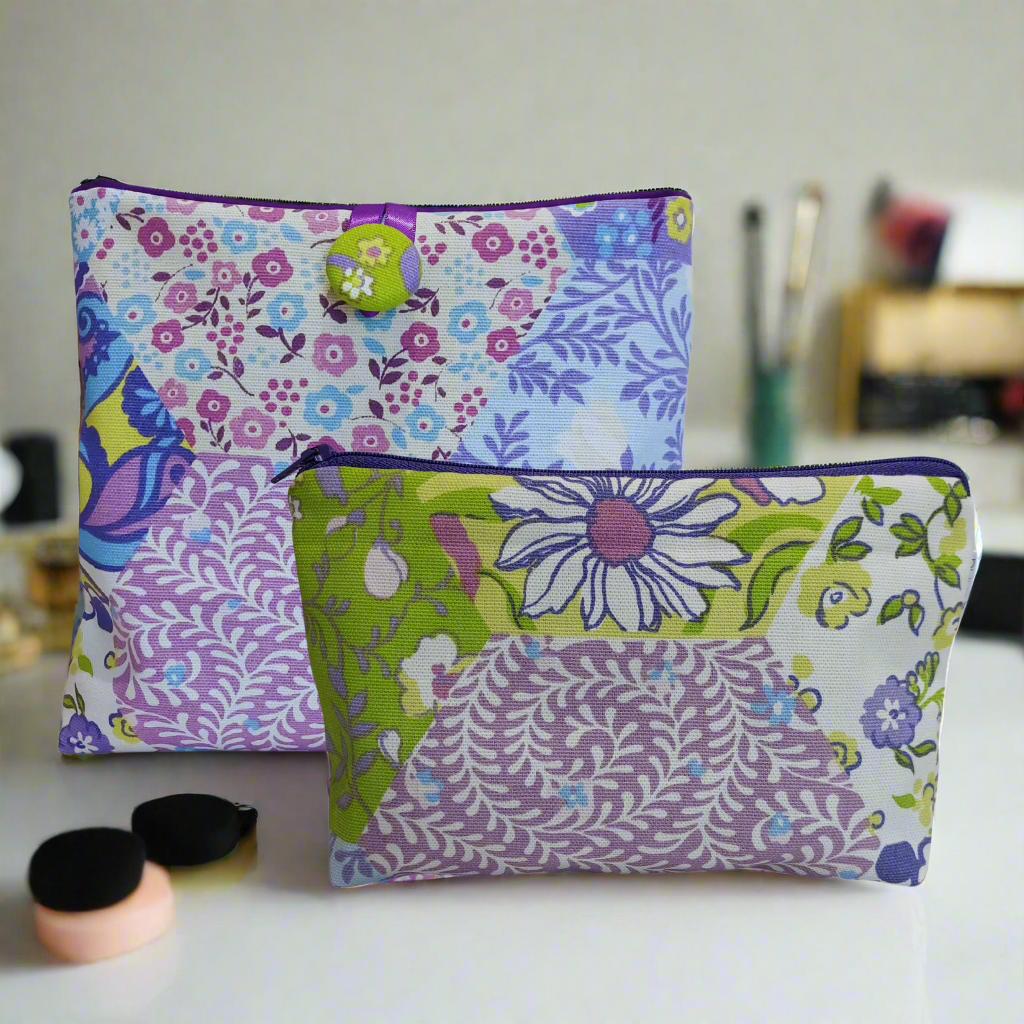 2 purple and green make up bags. 1 with zip fastening and other with hand covered button.