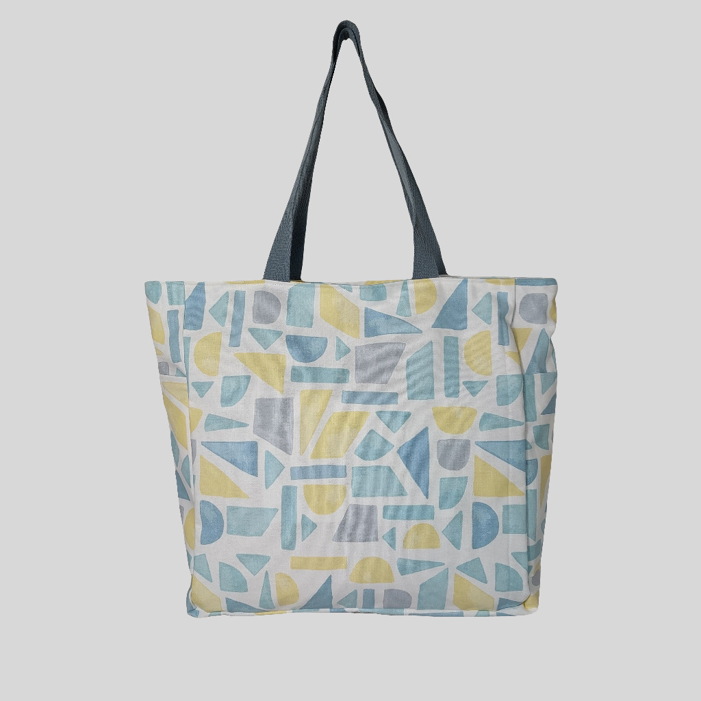 Front view of summery pastel print beach bag. 