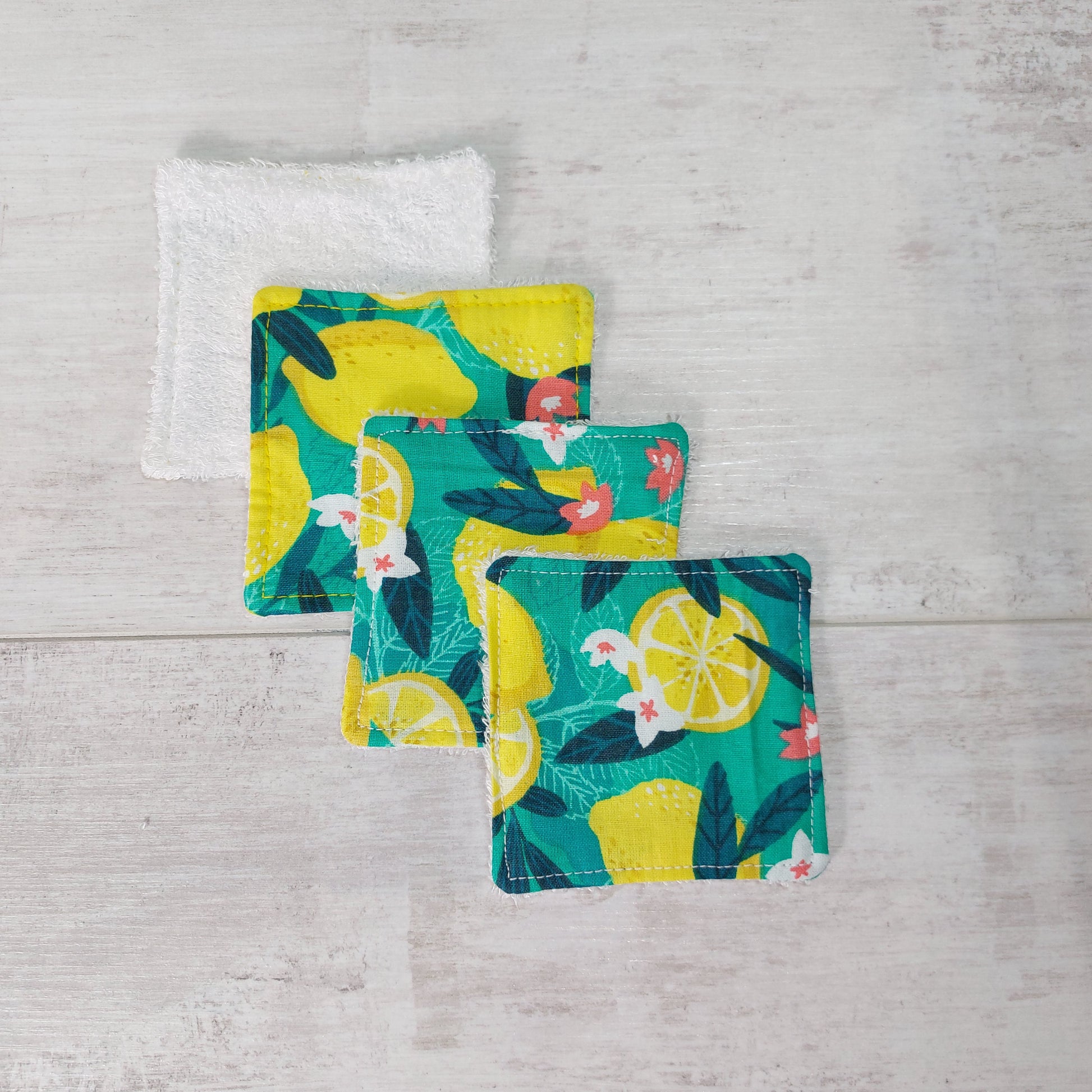 Four bamboo face wipes overlapping, in bold green and yellow Sicilian lemon print.