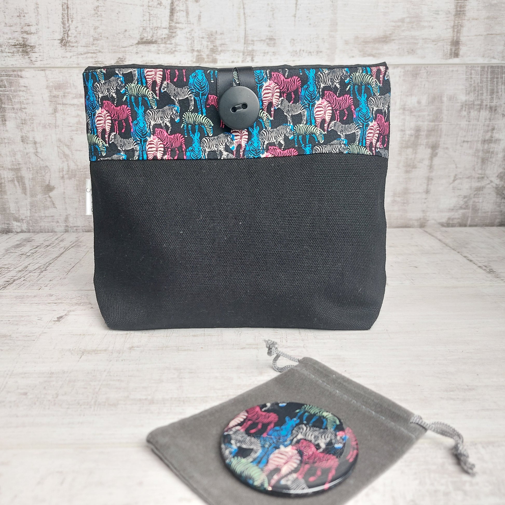 Black button pouch with colourful zebra print top and zebra print compact mirror with pouch.