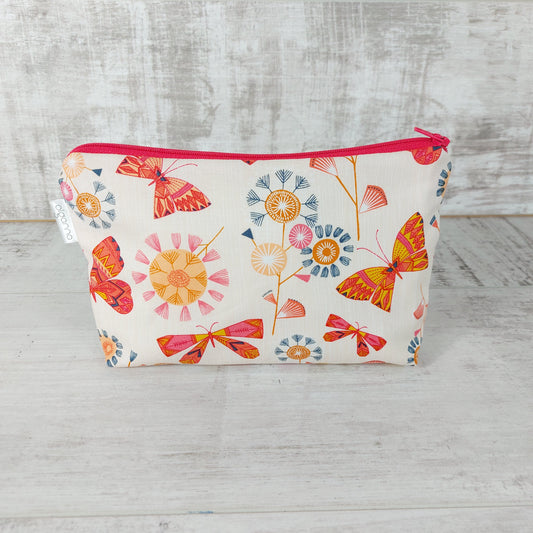 Front view of Spring floral and butterfly print makeup bag. 