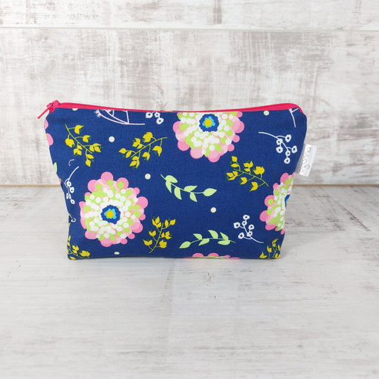 Front view of royal blue Spring floral print makeup bag. 