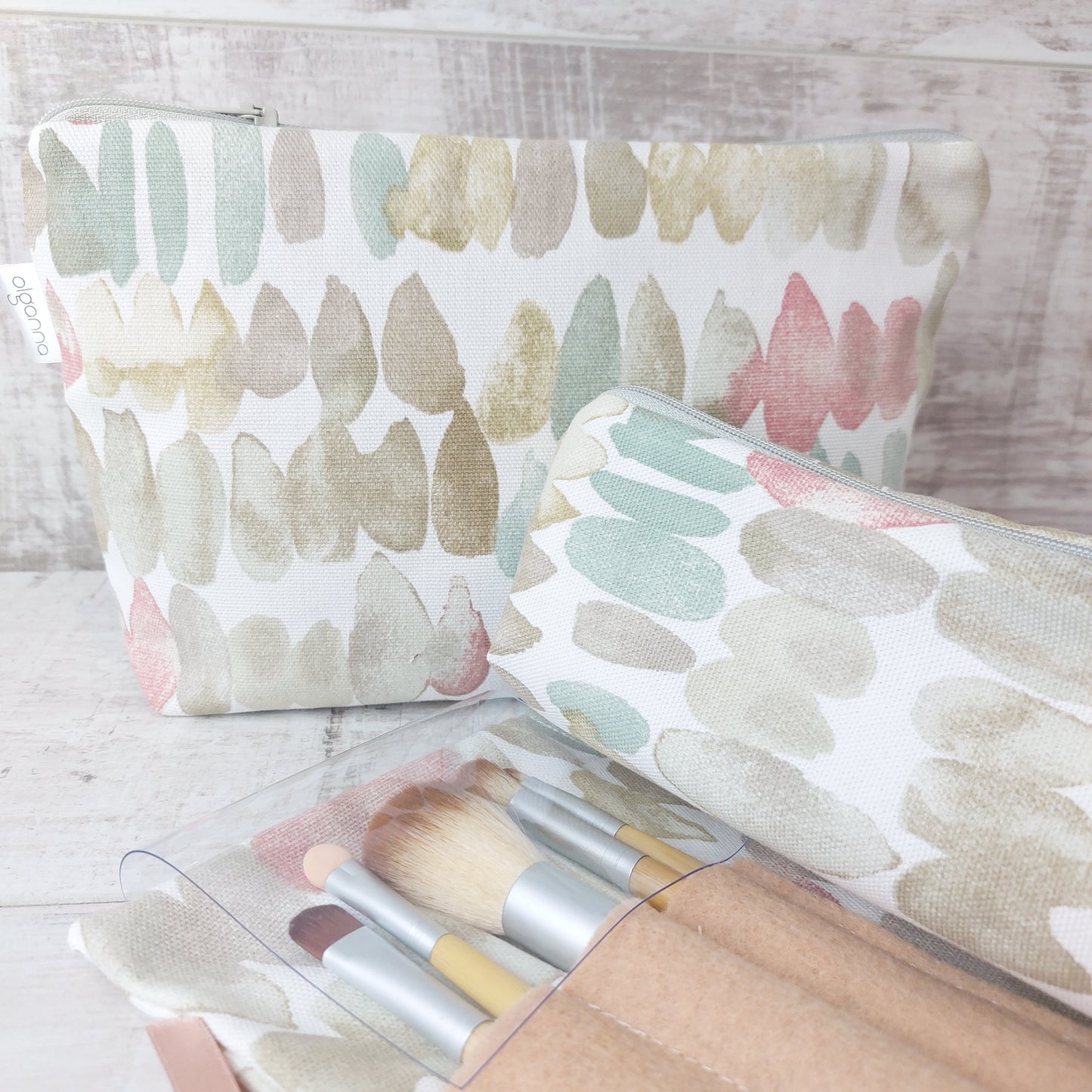 Closeup of natural stones print makeup wrap, open to reveal brushes pouch, pictured with matching makeup bag, by Olganna.