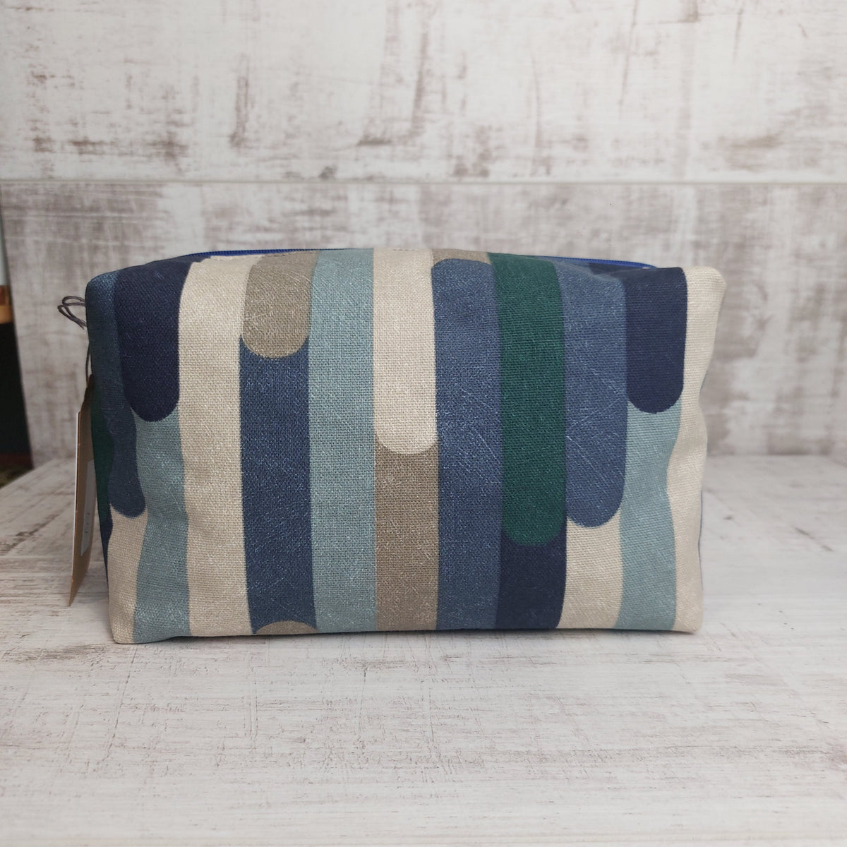 Boxy zip pouch in blue and winter tones stripe pattern.