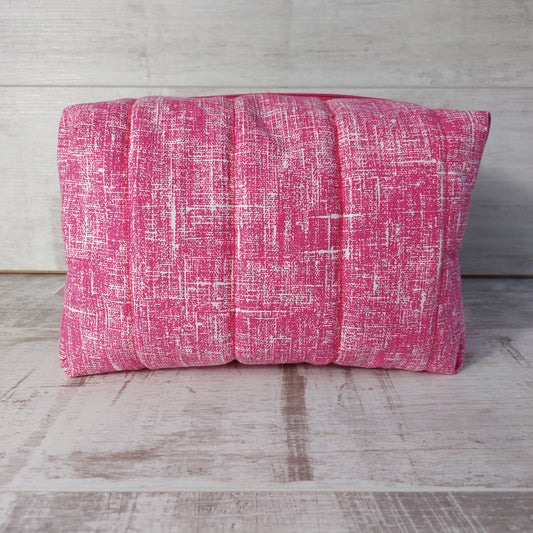 Pink quilted large toiletries bag, side view.