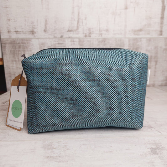 Boxy zip pouch in teal and black woven fabric with Olganna gift tags.