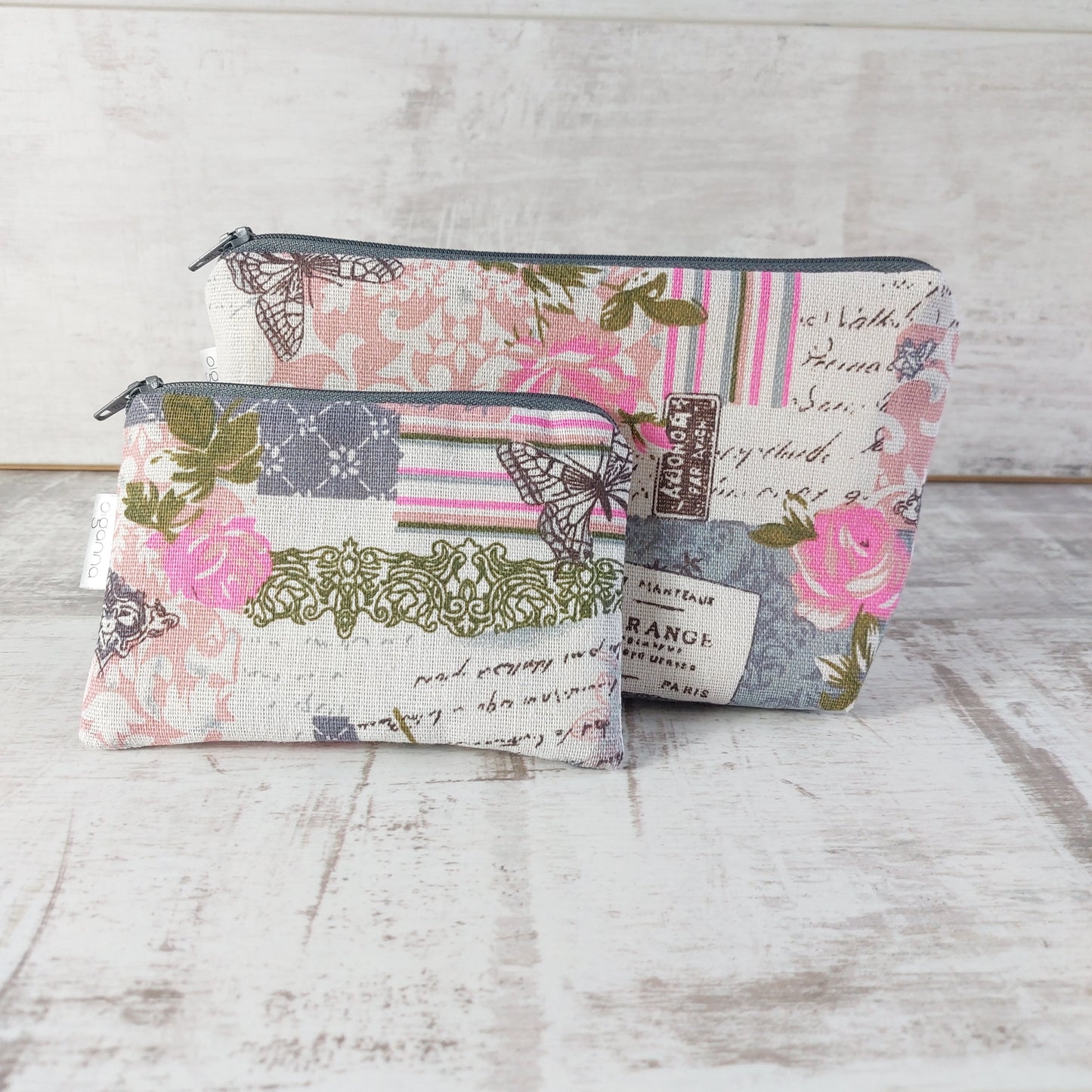 Pink and grey vintage rose and butterfly print makeup bag pictured with a matching zip purse in front, by Olganna.