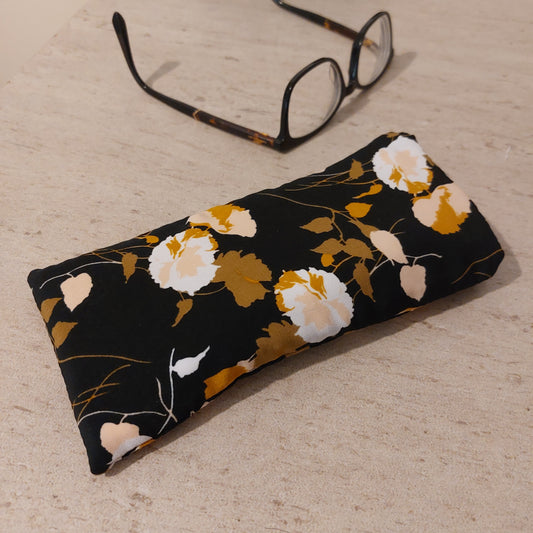 Black floral print glasses case, pictured with glasses.