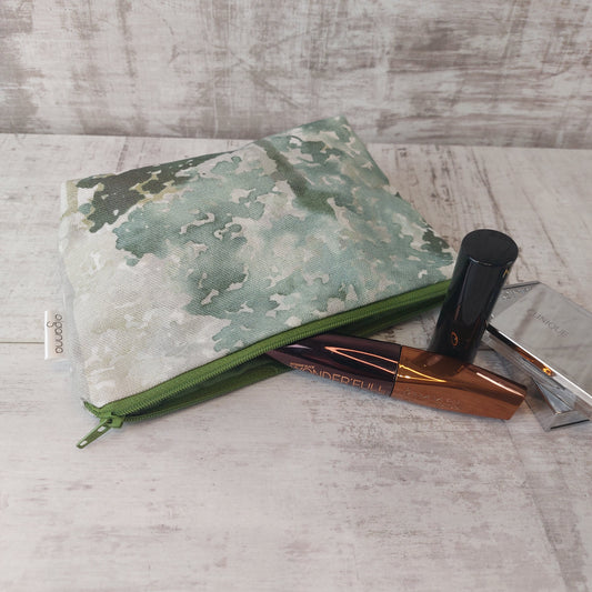 Make up bag in Forest Green Tree Print with open zip fastening, pictured with makeup essentials.