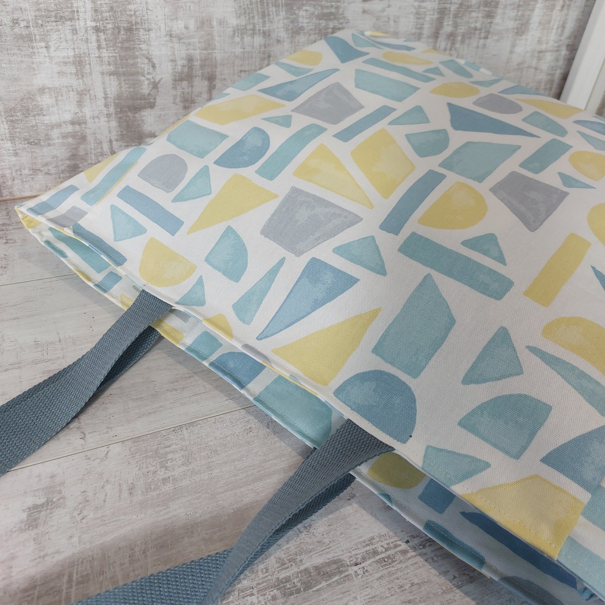 Summery pastel print beach bag, lying down. 