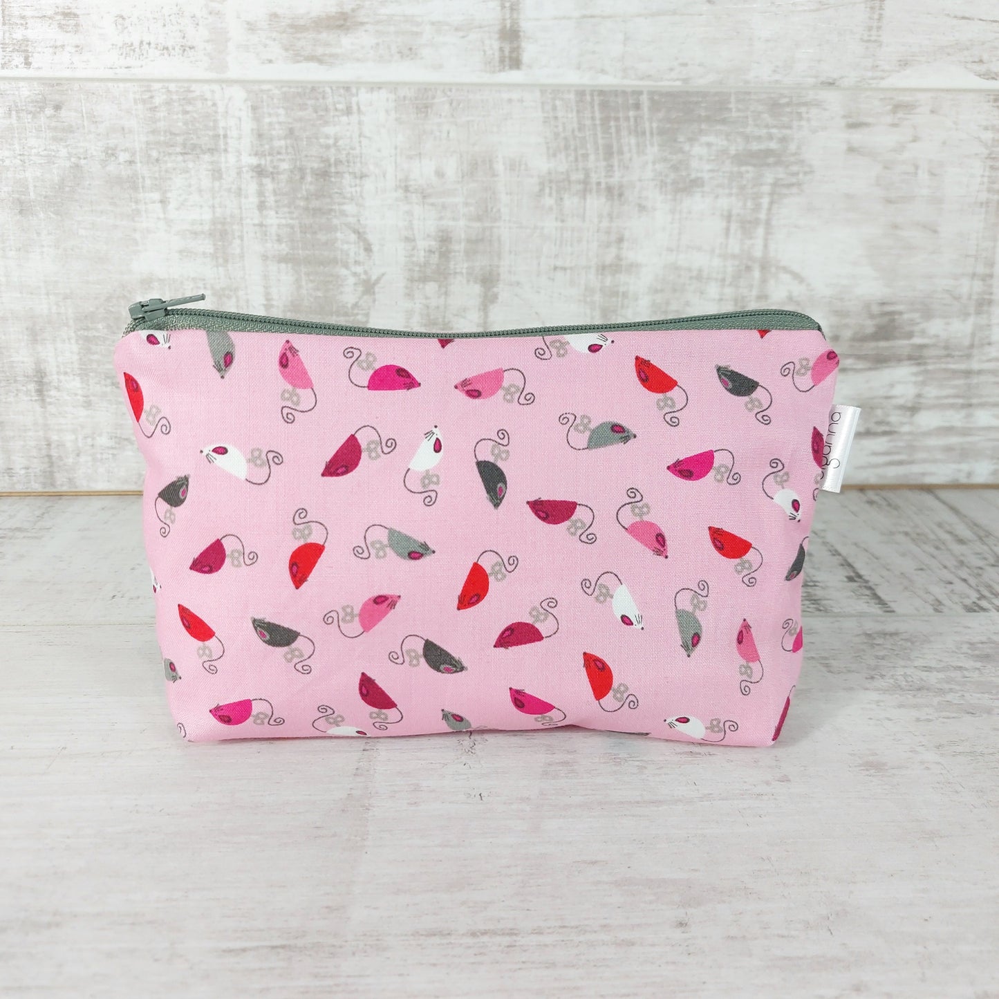 Front view of pink mice print makeup bag. 