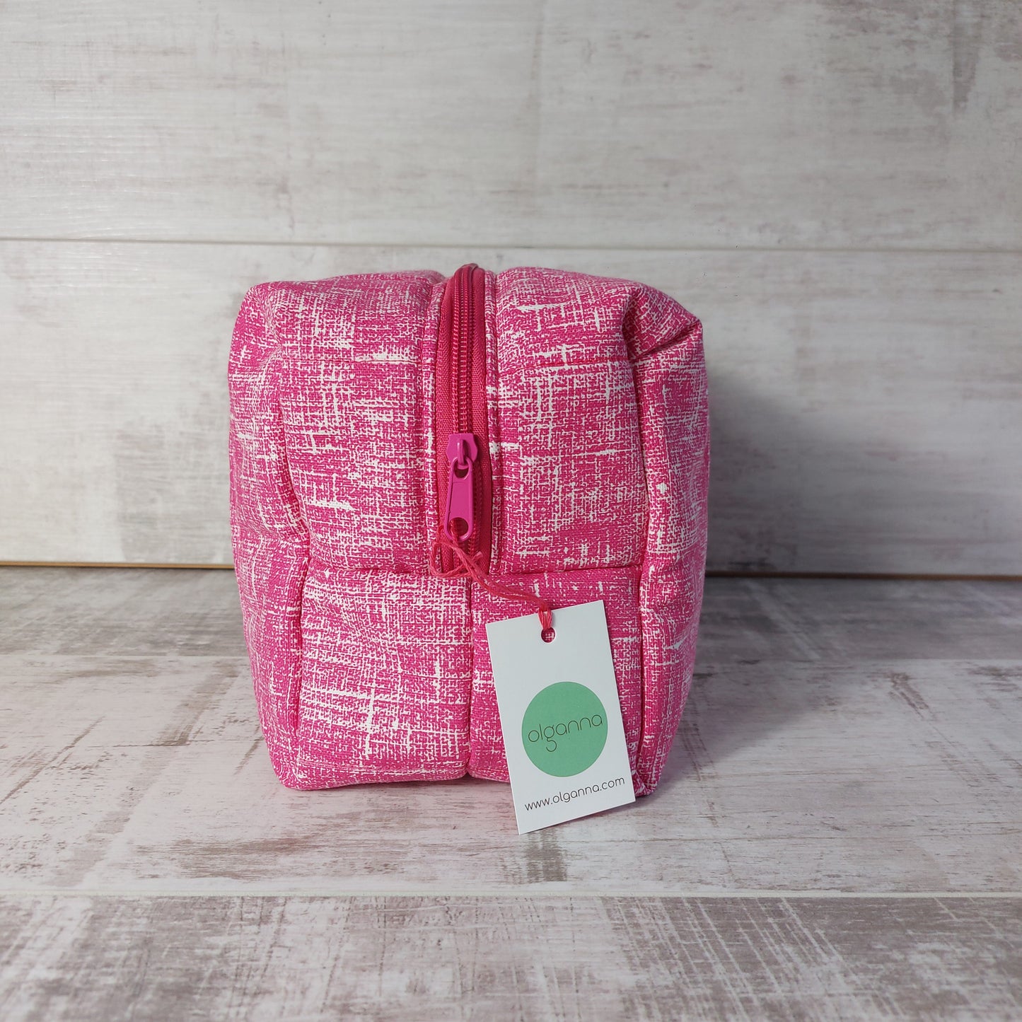 Pink quilted large toiletries bag, end view, showing Olganna gift label.