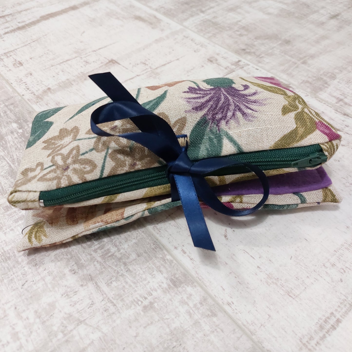 Floral make up bag, closed with navy ribbon ties