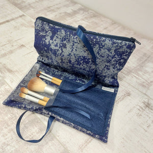 Navy make up bag and brushes in pocket