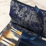 Close up of Navy Make up Bag and brushes by Olganna