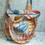 Large textile bag with blue and orange leaf print. 