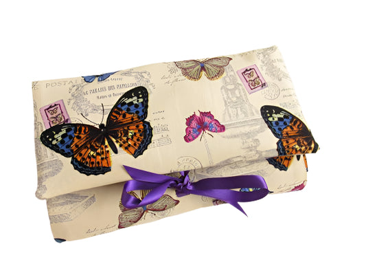 Vintage Style Butterfly Print Make Up Case. Pictured folded with purple ribbon ties.